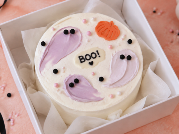 Halloween bento cake met spookjes, pompoen en BOO! in een witte doos".